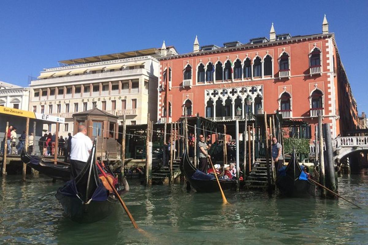 a group of gondolas in the water in front of a building