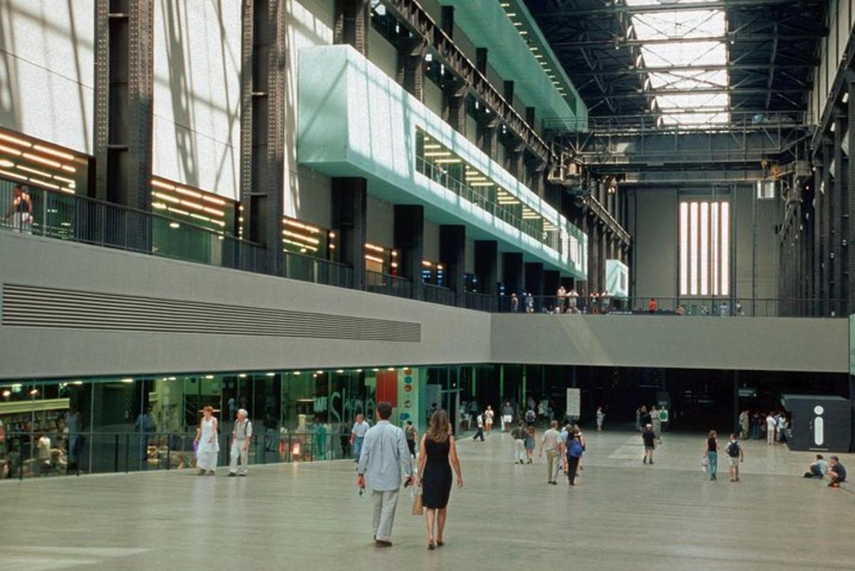 a group of people walking through a large building