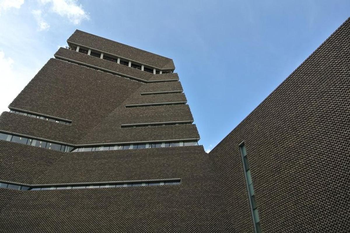 a tall brick building with a blue sky in the background