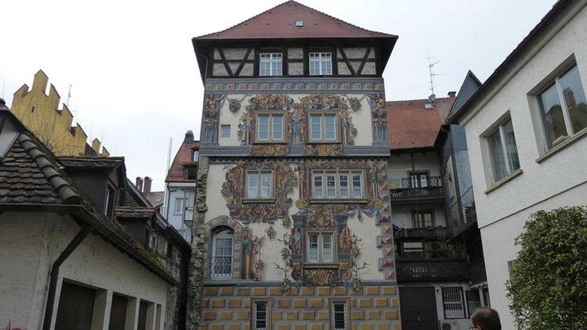 a tall building with a clock tower on a street