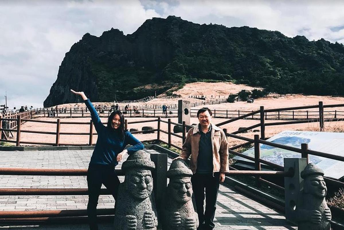 a man and a woman standing next to some statues