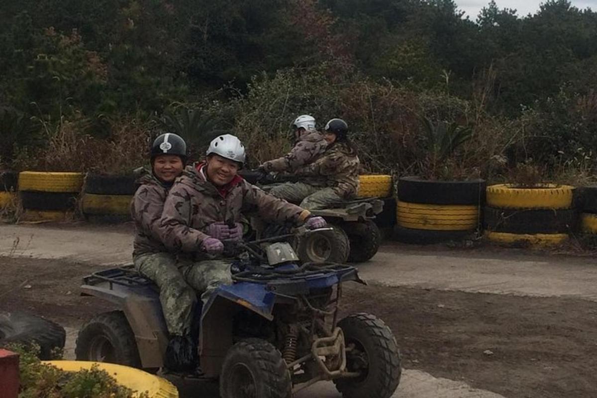a group of people riding on a four wheeler