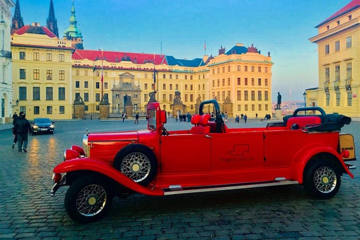 an old red car parked in front of a building