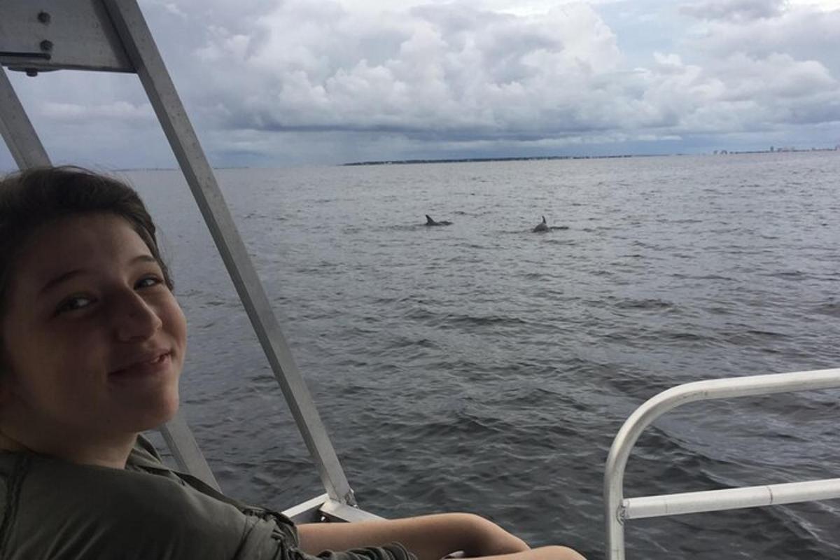 a woman sitting on a boat in the water