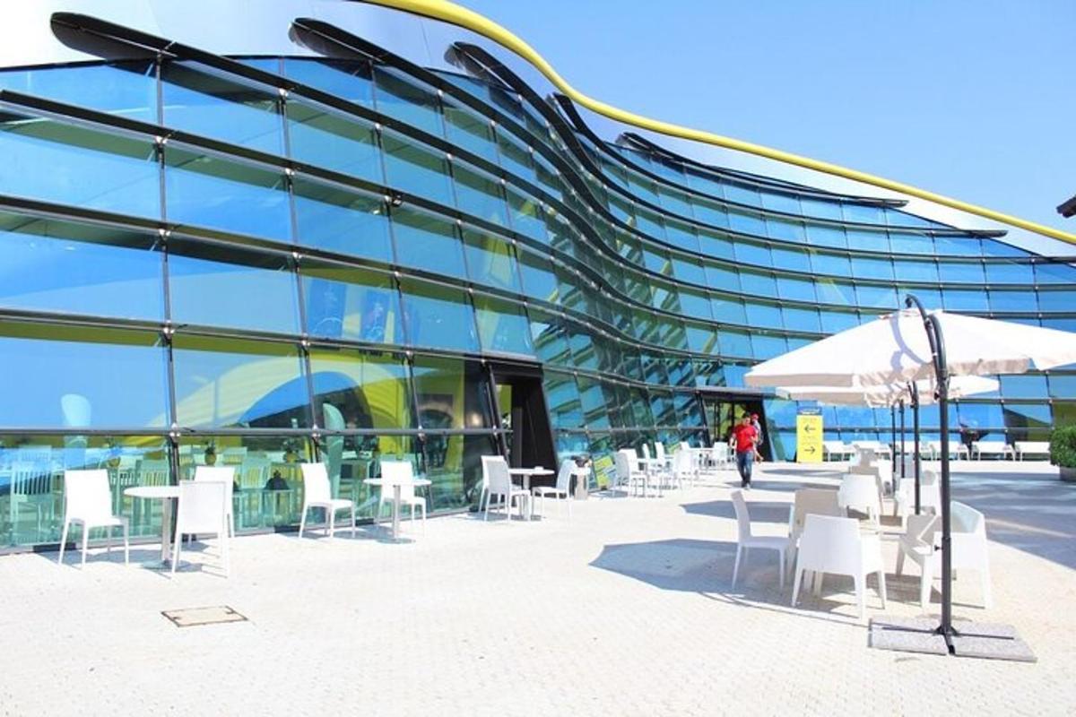 a building with white tables and chairs in front of it