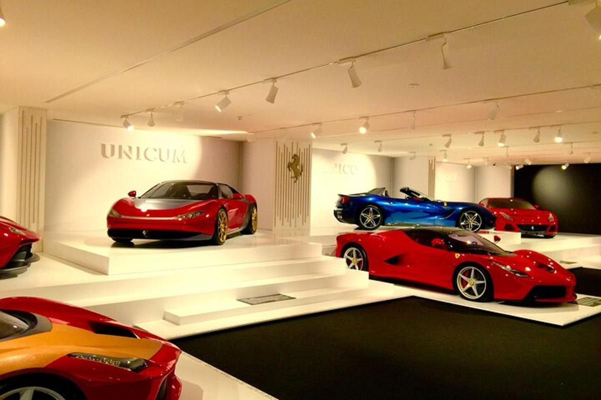 a group of cars on display in a car museum