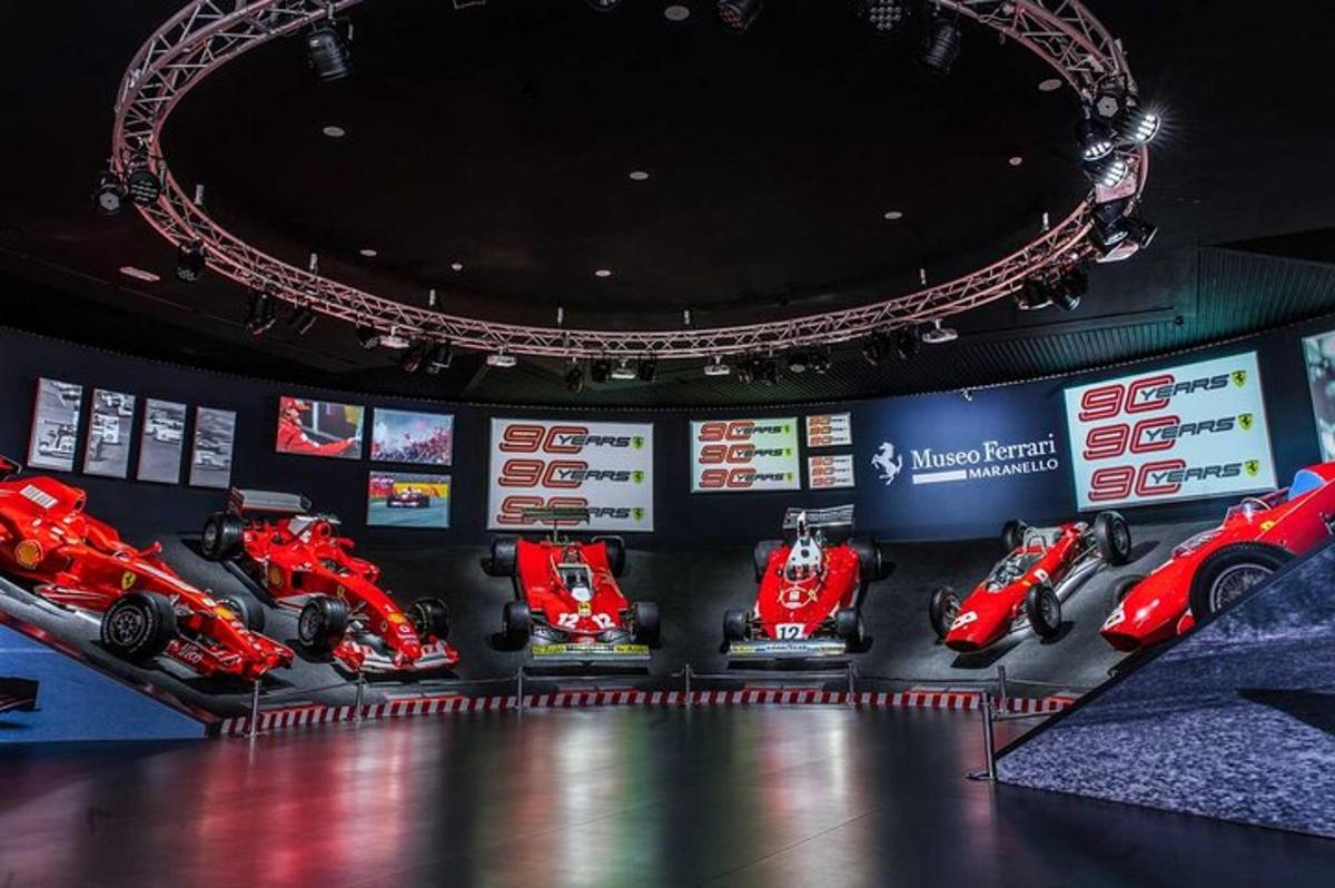 a room with a bunch of red motorcycles on display
