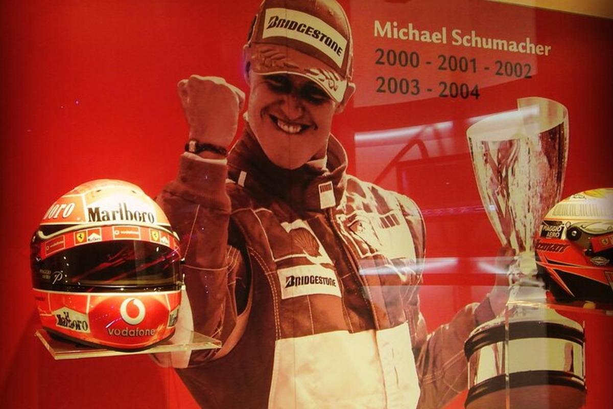 a picture of a man with a motorcycle helmet and a trophy