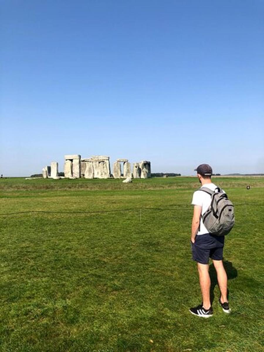 a man with a backpack standing in a field