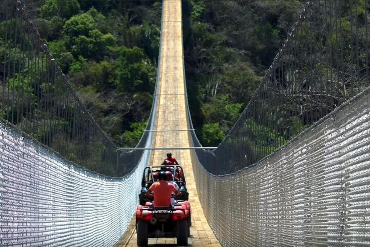 a group of people riding on a suspension bridge