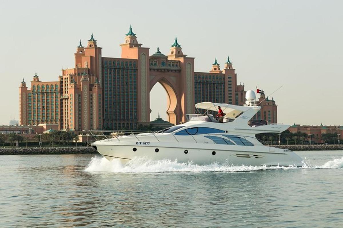a yacht in the water in front of a city