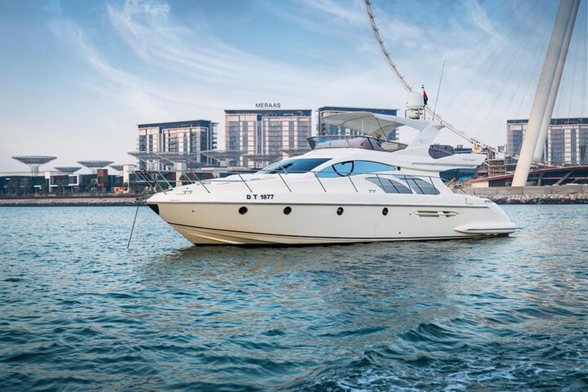 a white boat sitting in the water near a city