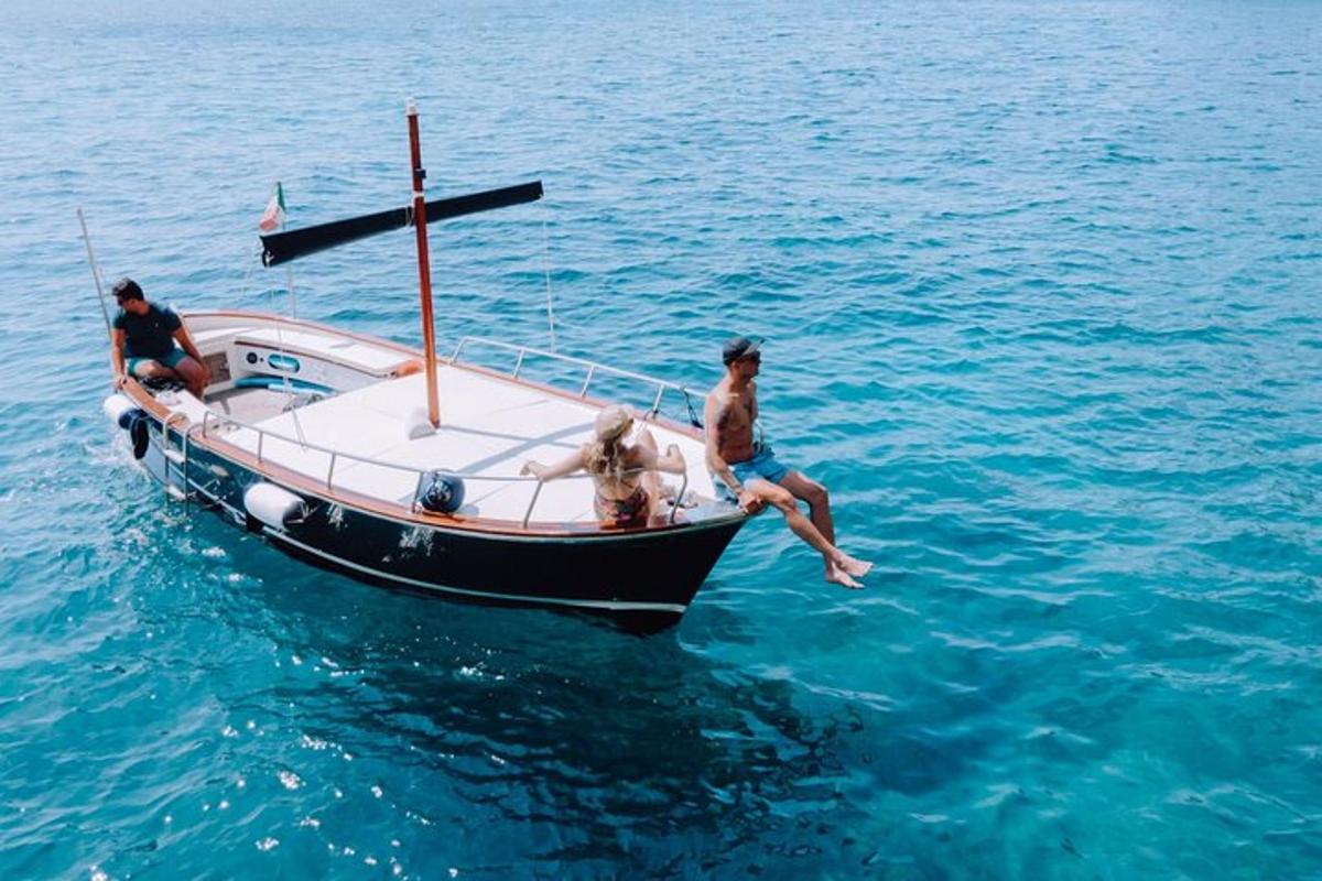 three people on a boat in the water