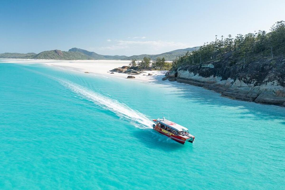 a boat in the water next to a beach