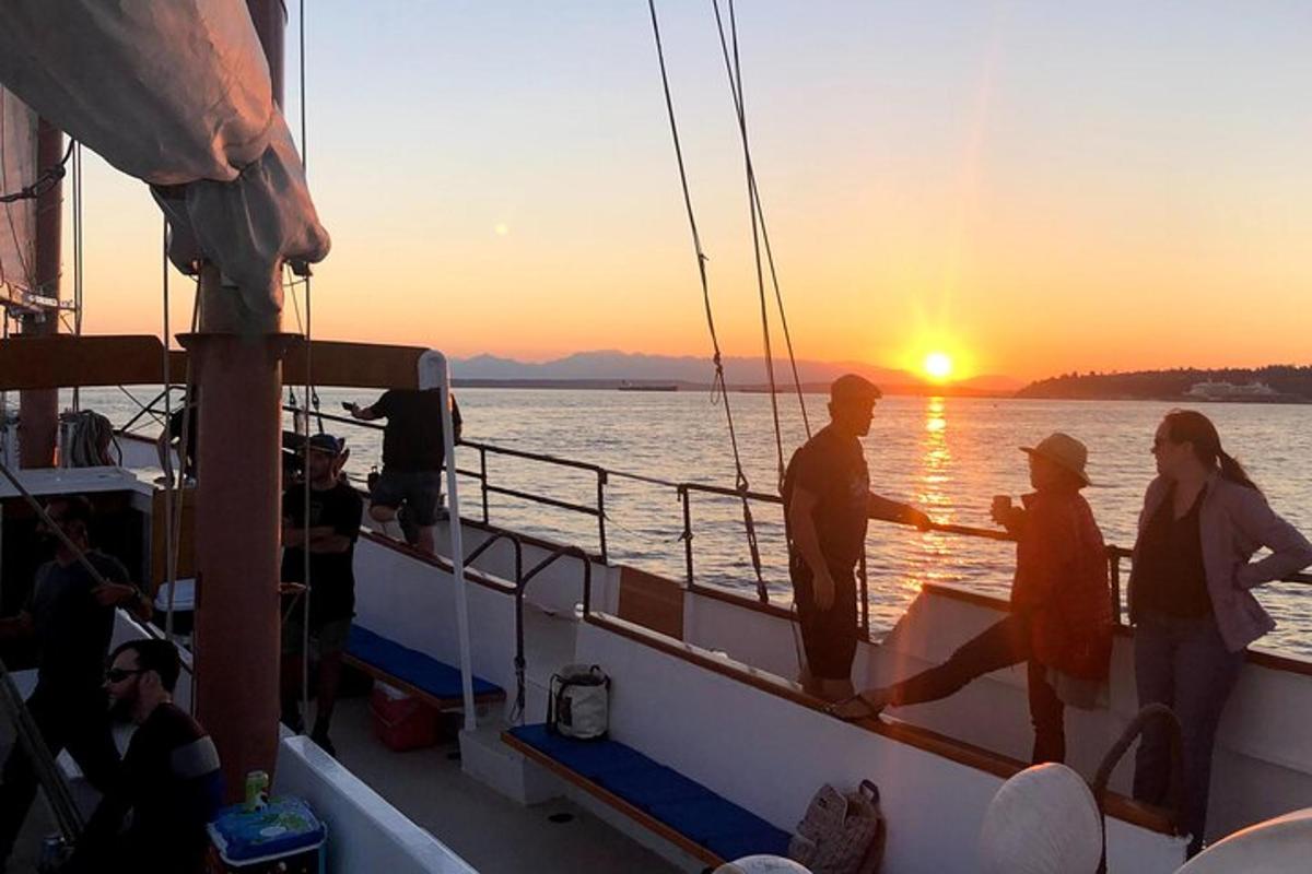a group of people on a boat at sunset