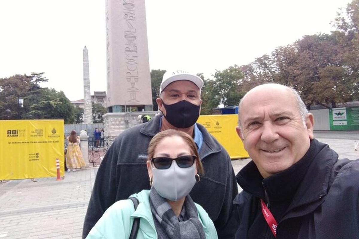 two men and a woman wearing a gas mask