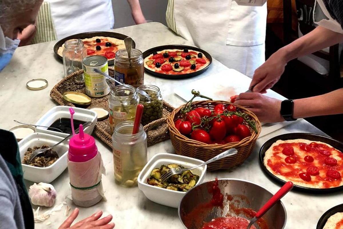 a group of people standing around a table with food
