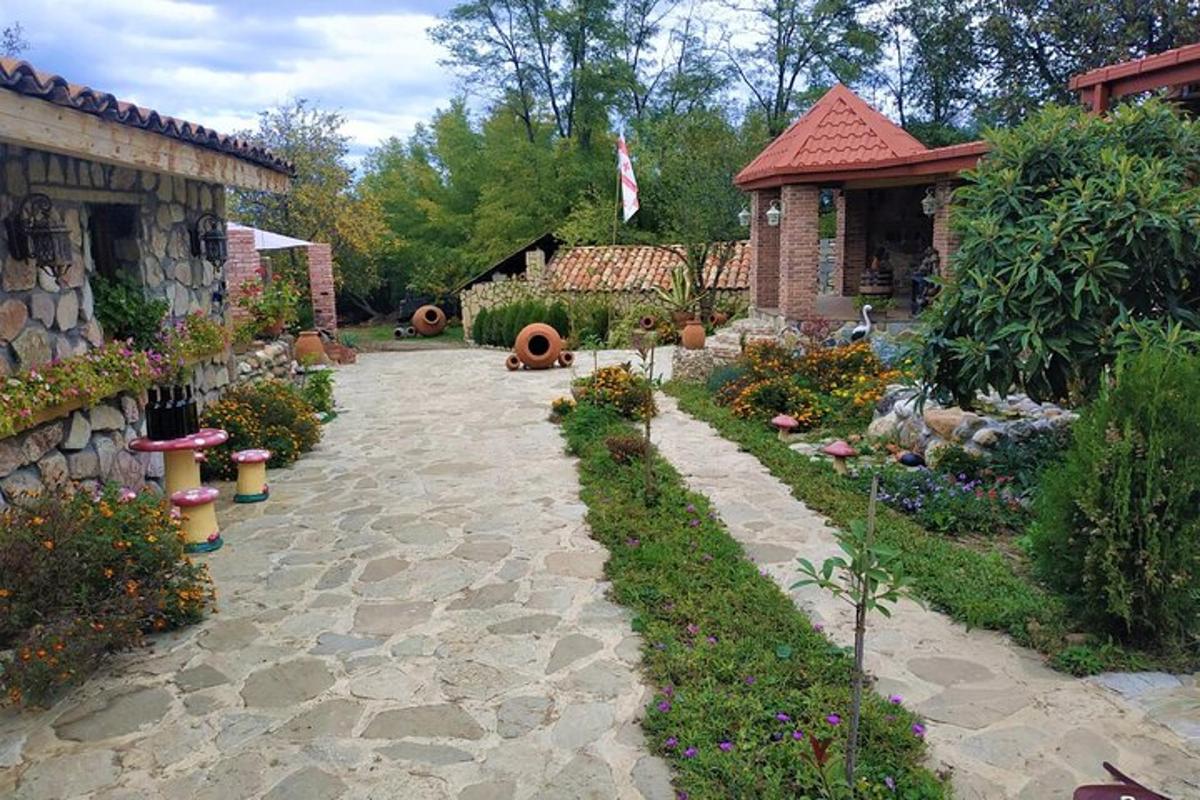 a garden with a stone pathway and a house