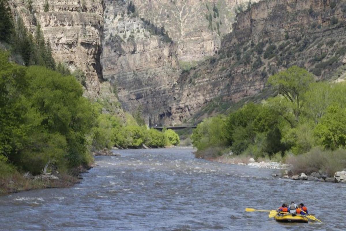a group of people in a raft on a river