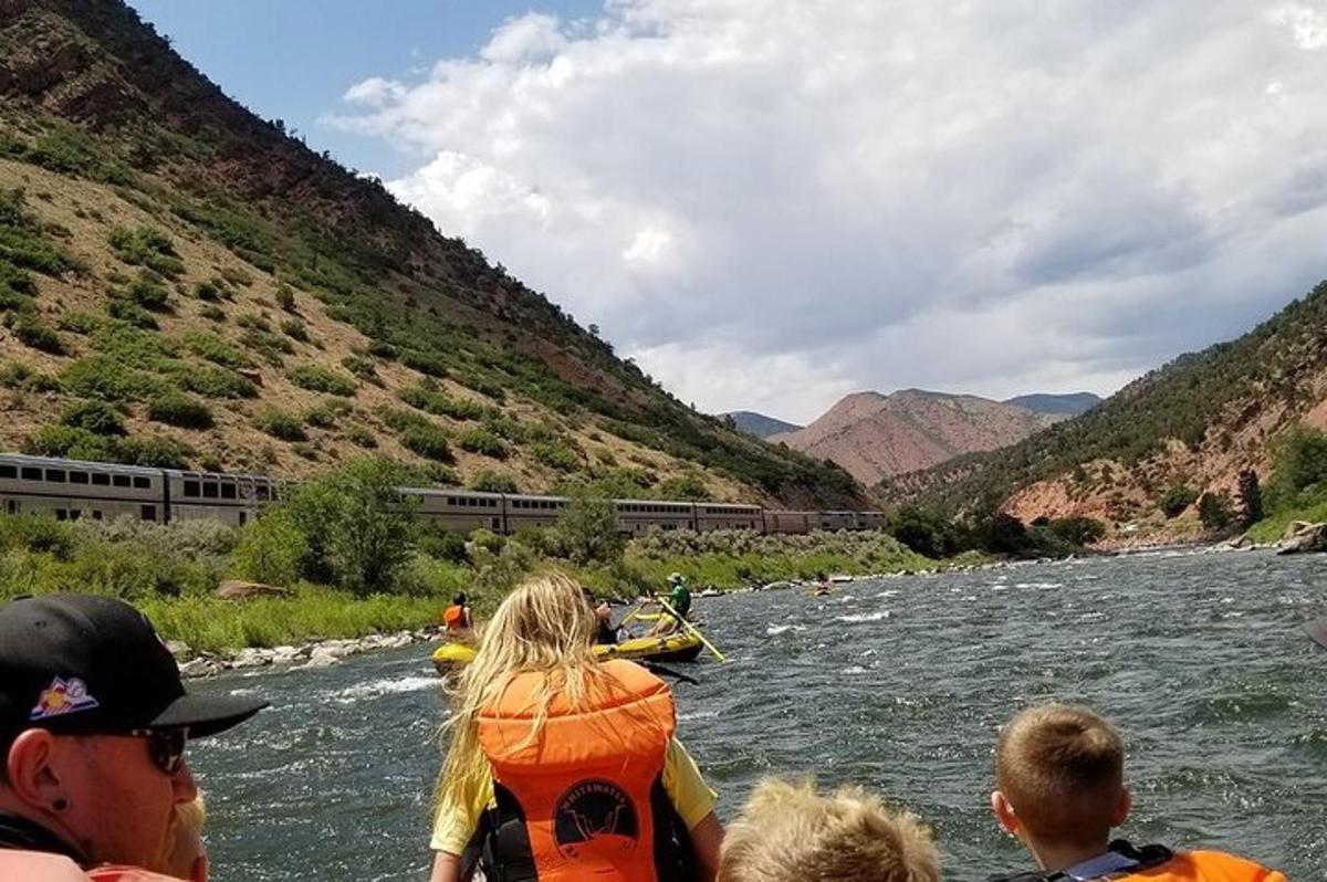 a group of people in a boat on a river