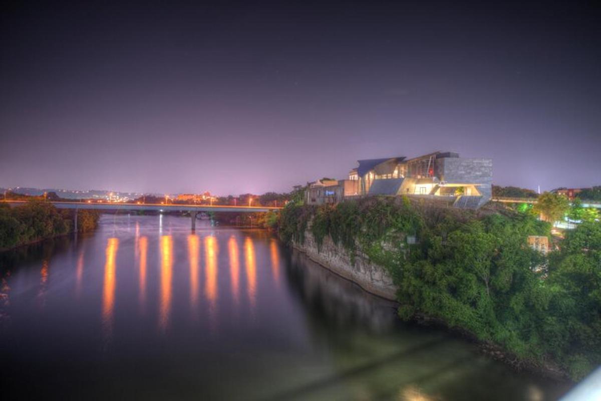 a view of a river at night with buildings
