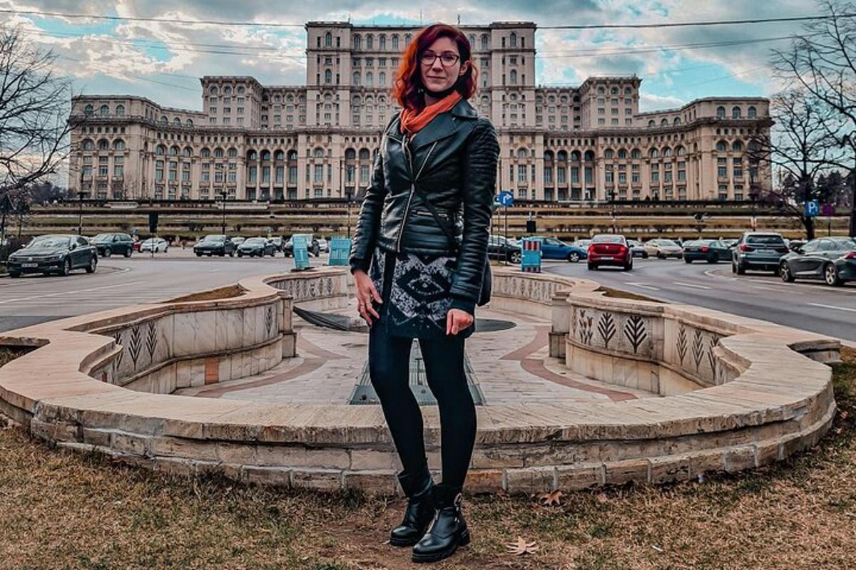 a woman standing in front of a large building