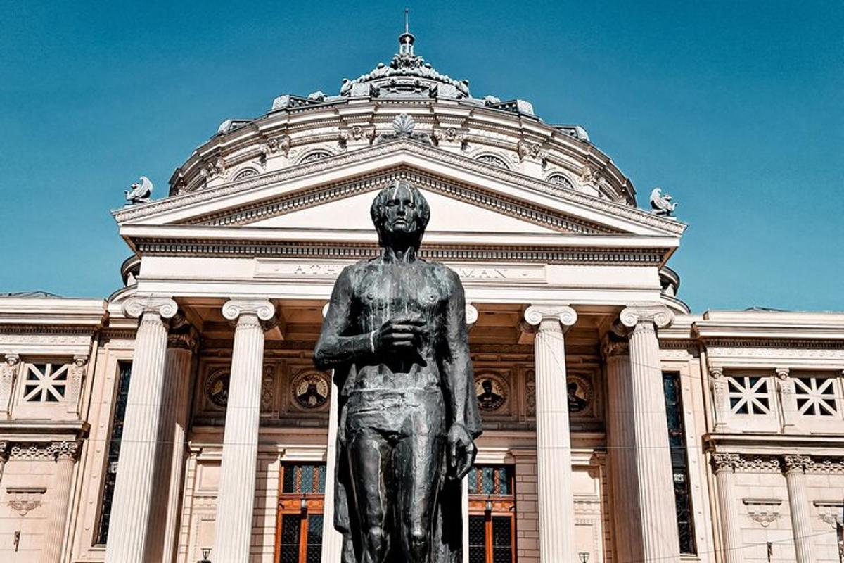 a statue in front of a large building