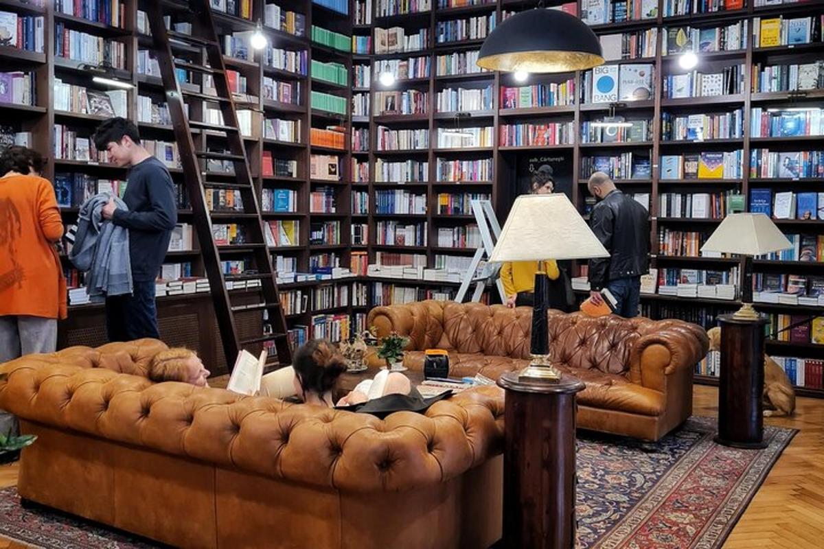 a woman laying on a couch in a library