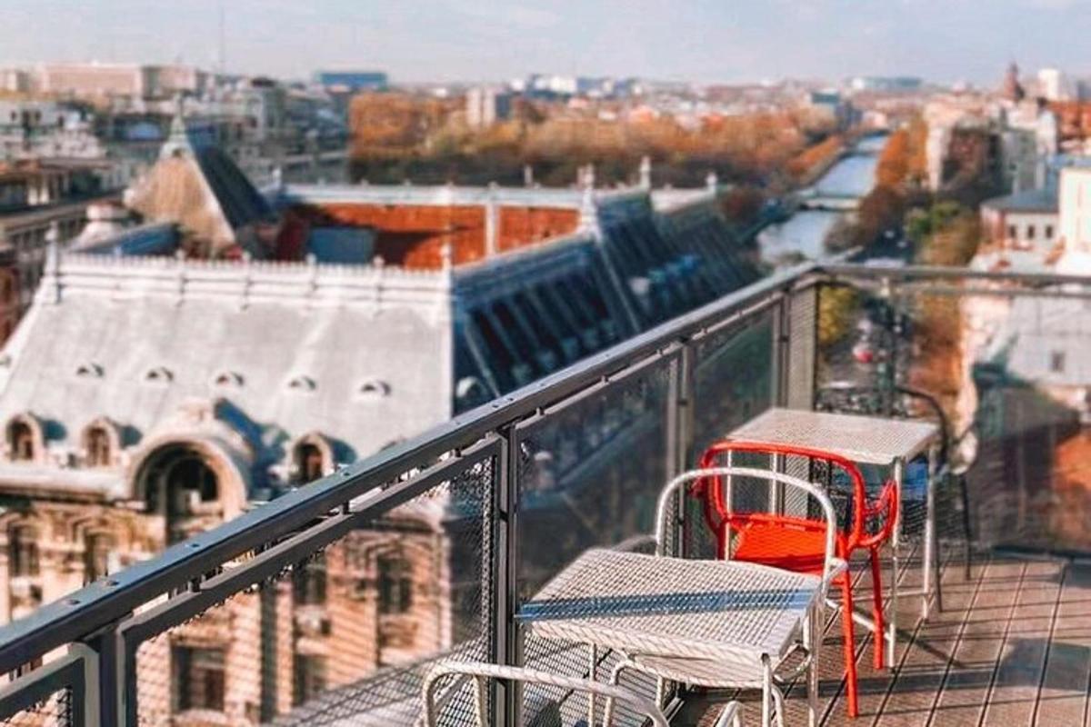 a table and chairs on a balcony with a view of a city
