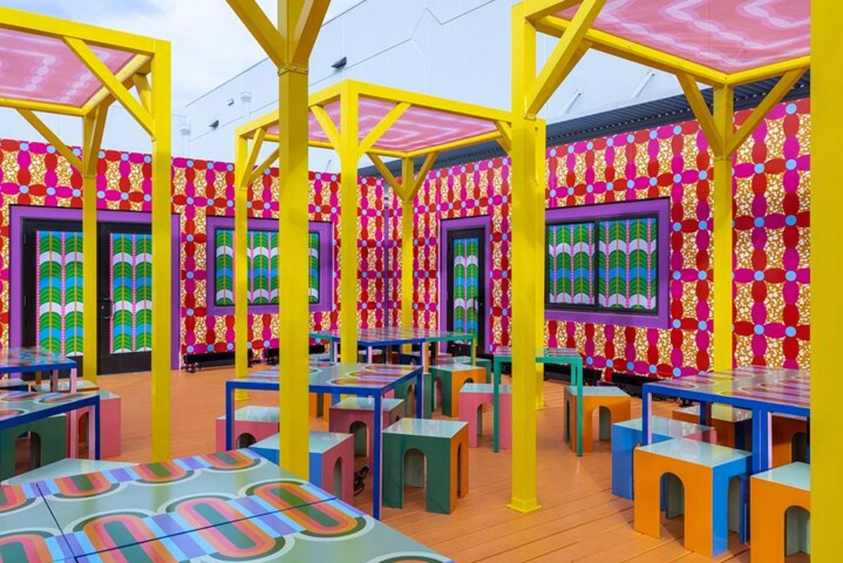 a brightly colored restaurant with tables and chairs