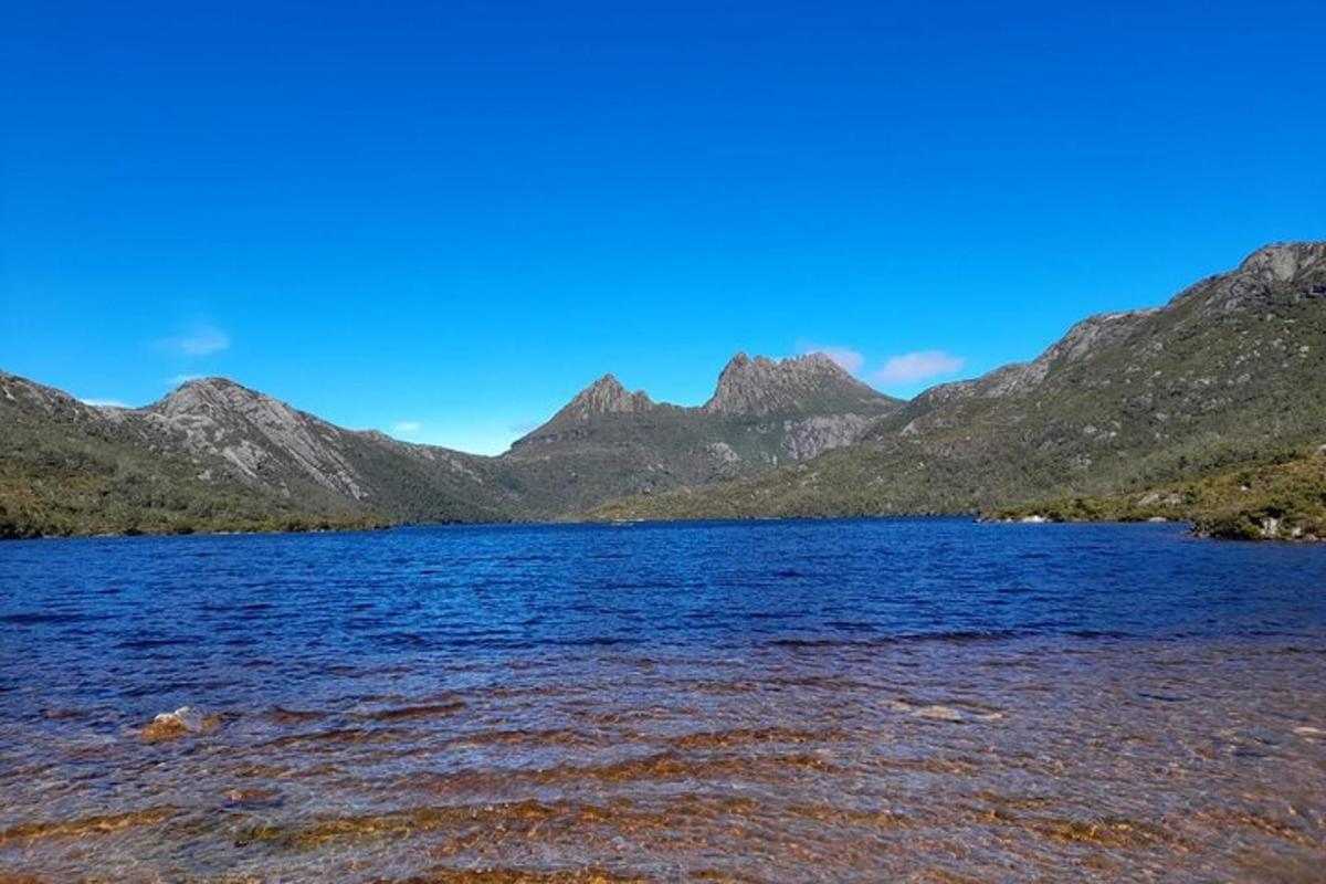 a large body of water with mountains in the background