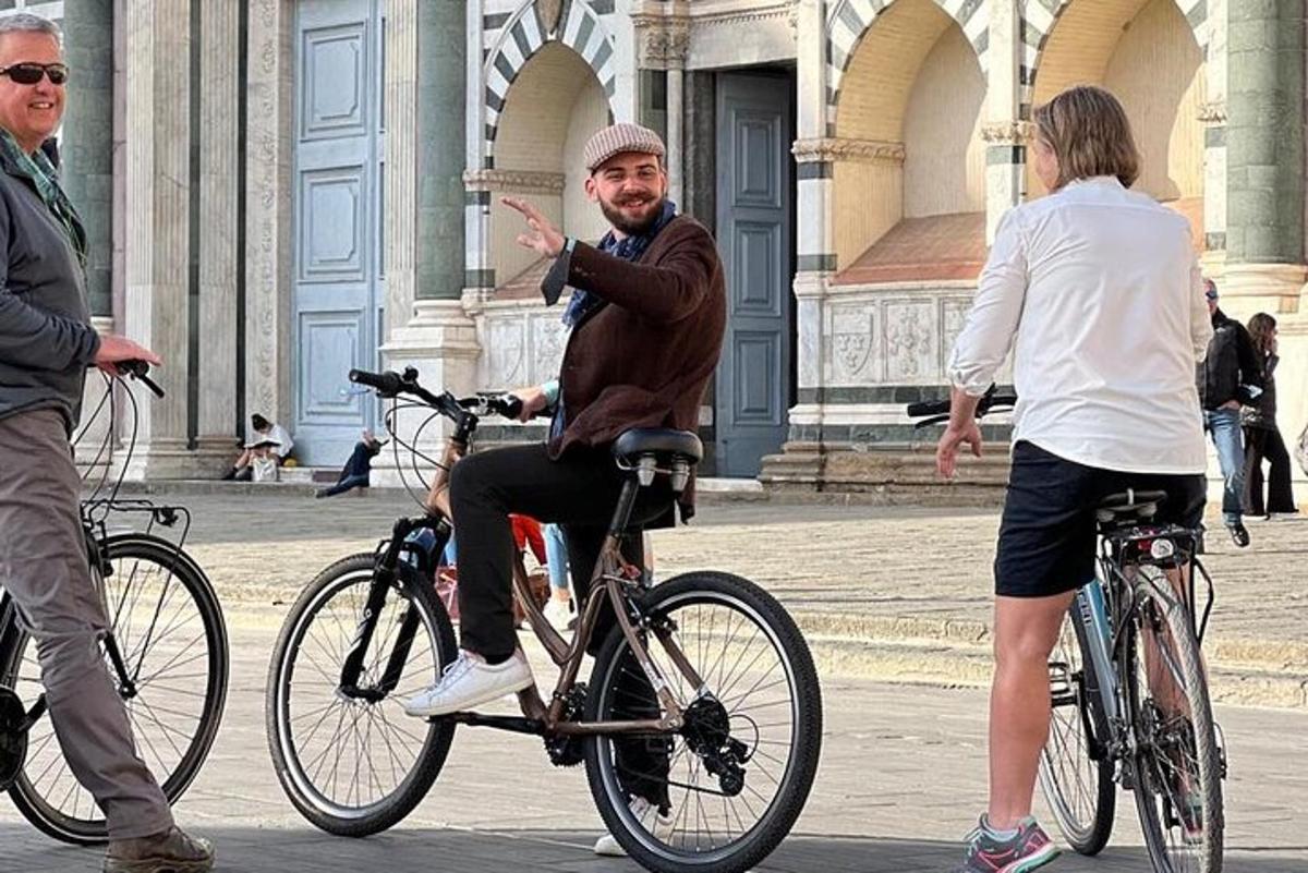 a man riding a bike on a street with a woman