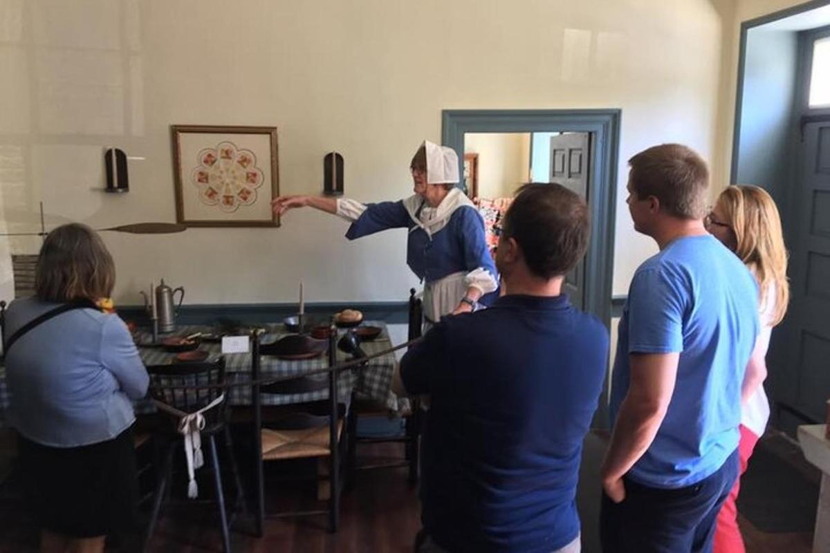 a group of people standing around a man in a room