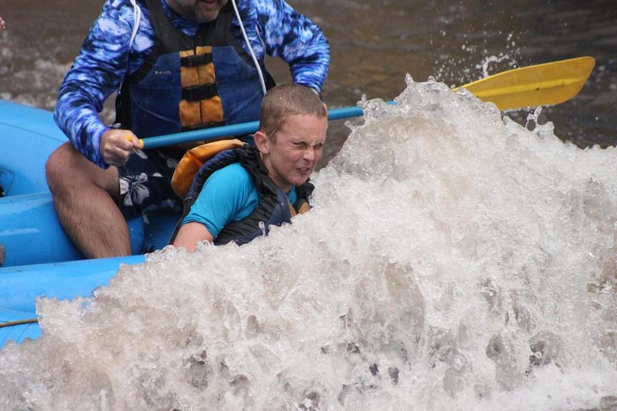 a man in a raft in a wave in the water