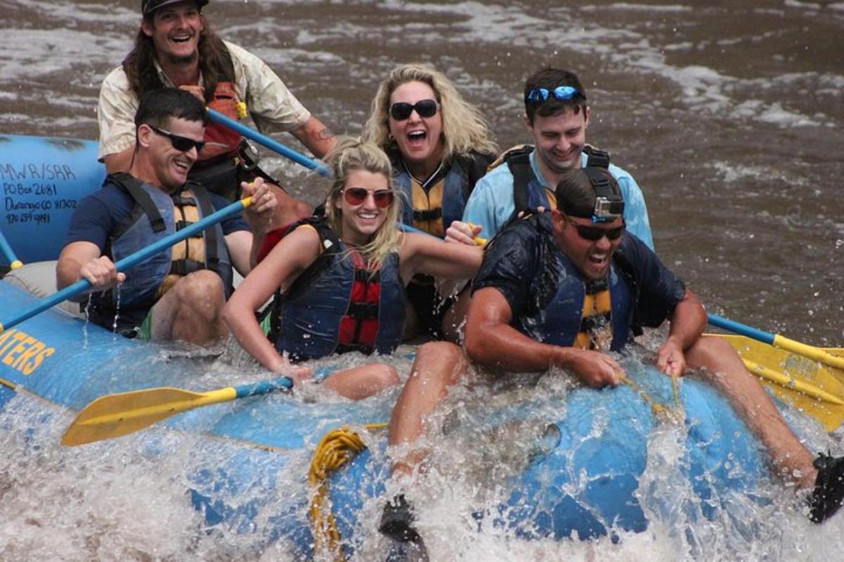 a group of people on a raft in the water