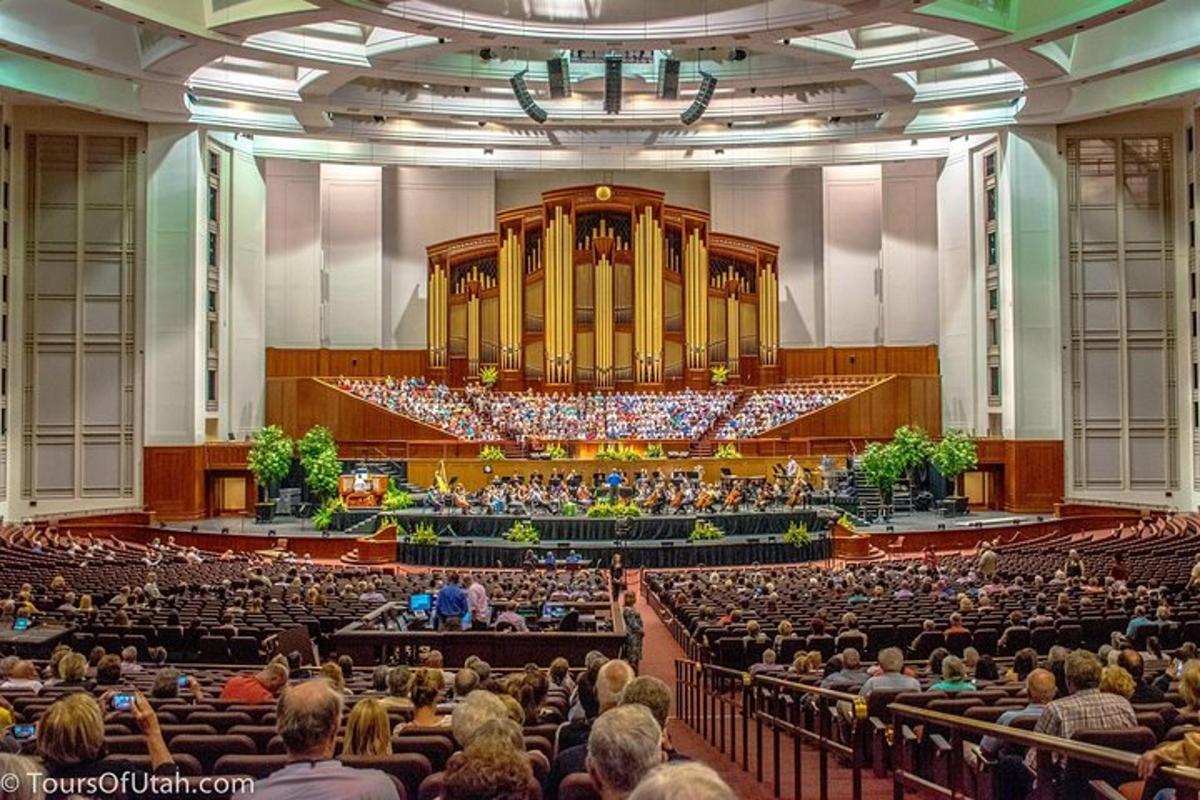 a large auditorium with a large organ and a crowd of people