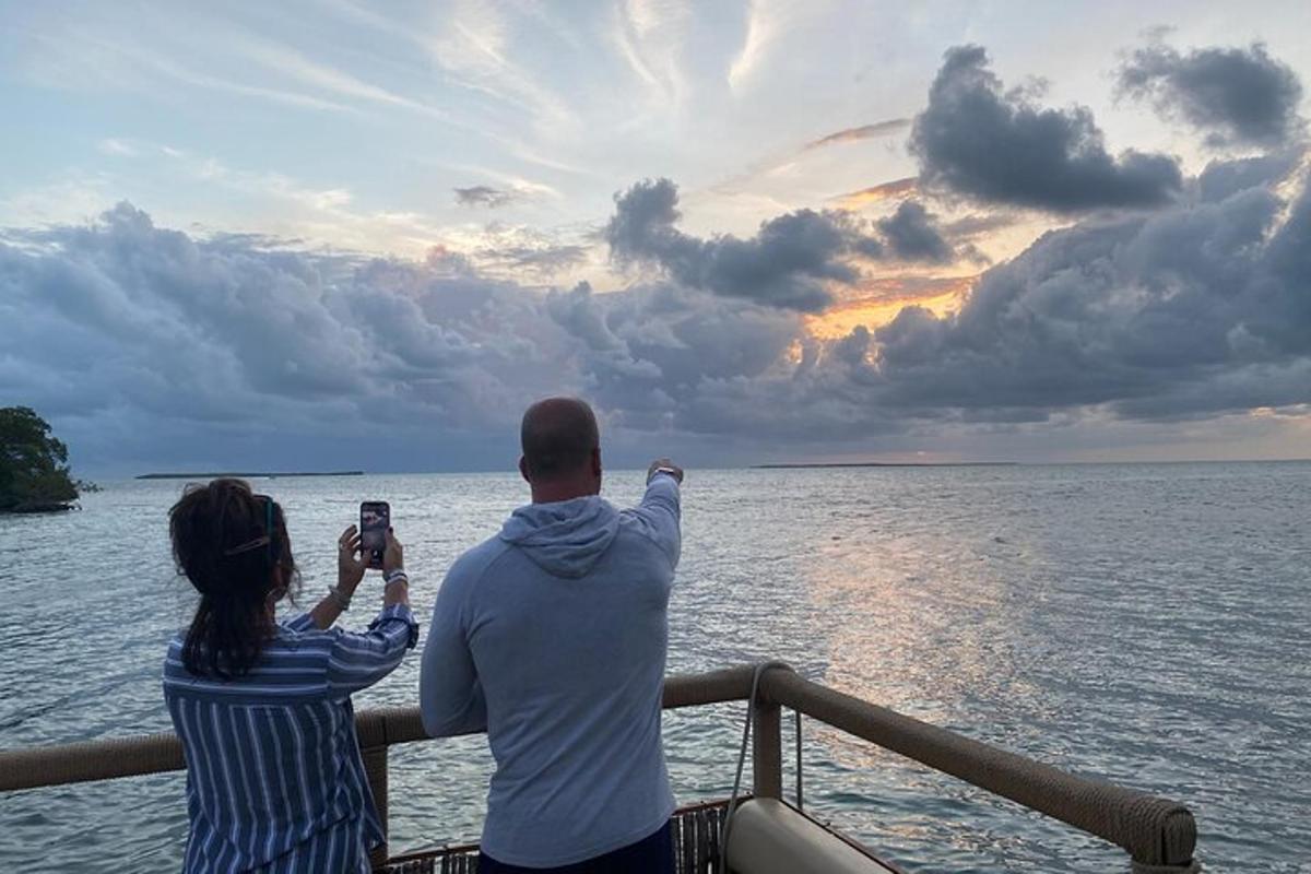 a man and woman taking a picture of the ocean