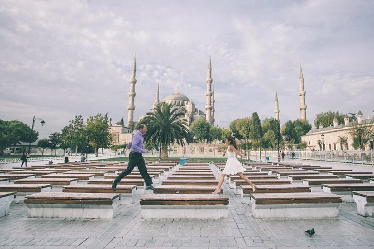 a man and a woman running on steps in front of a mosque