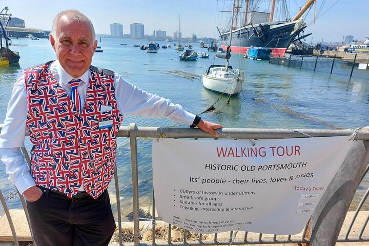 an older man is standing next to a warning sign