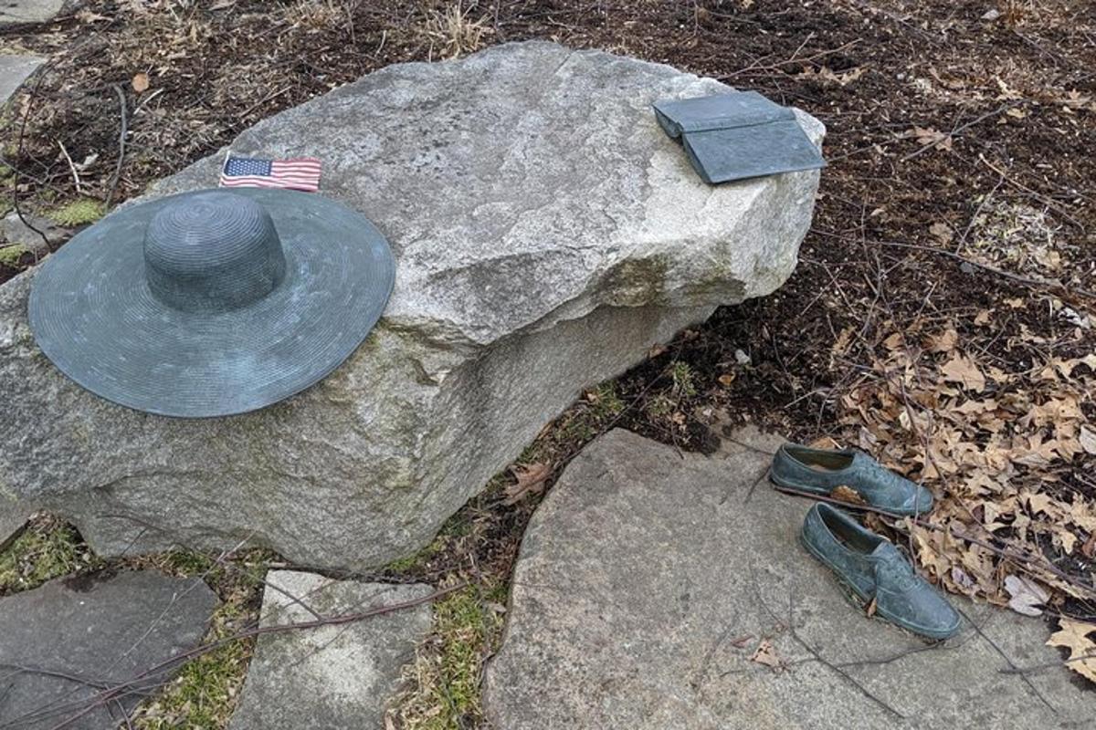 a statue of a hat on a rock