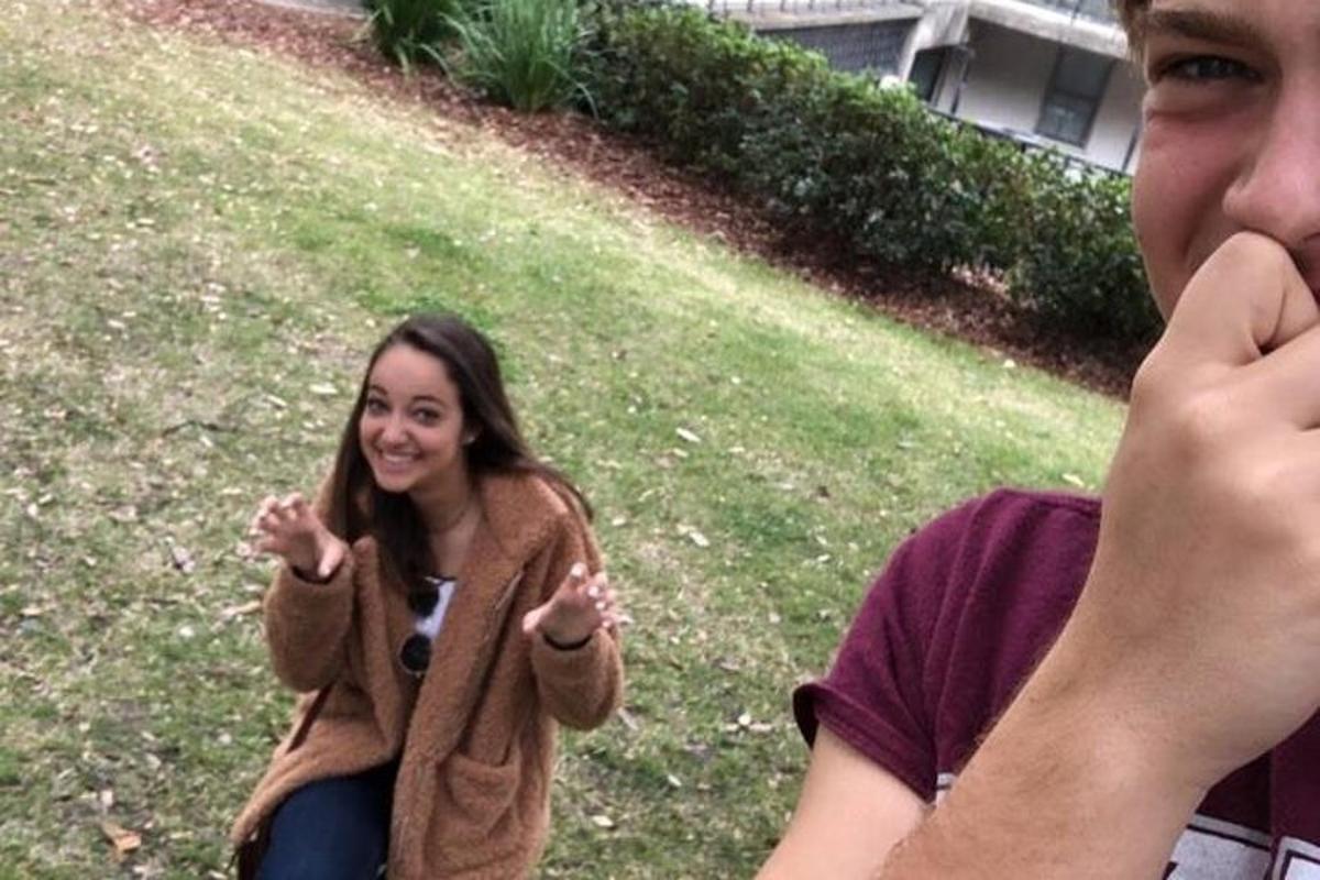 a woman talking on a cell phone next to a man