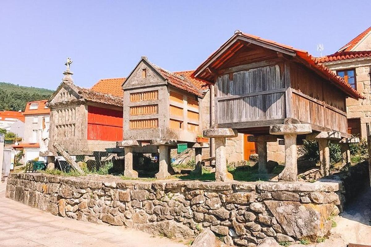 a group of wooden buildings with a stone wall