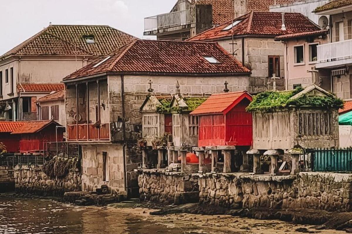 a group of houses with red doors next to the water