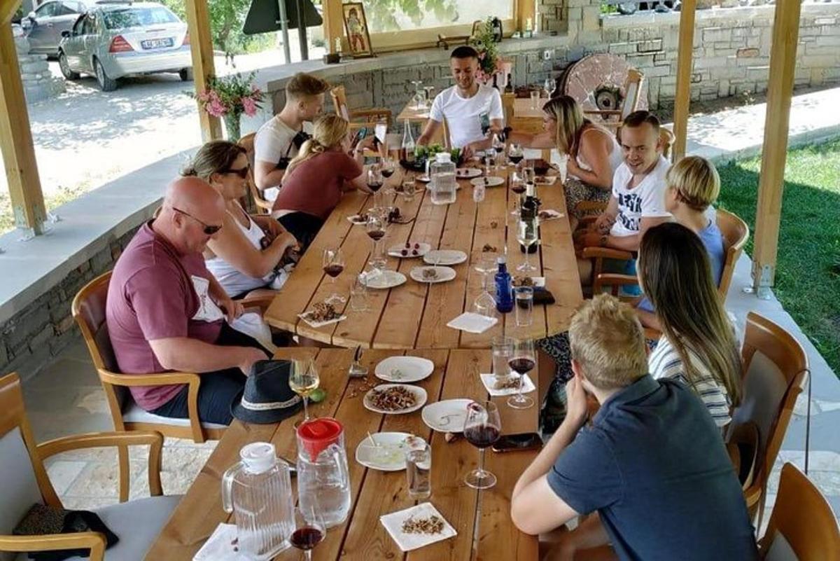 a group of people sitting around a long wooden table