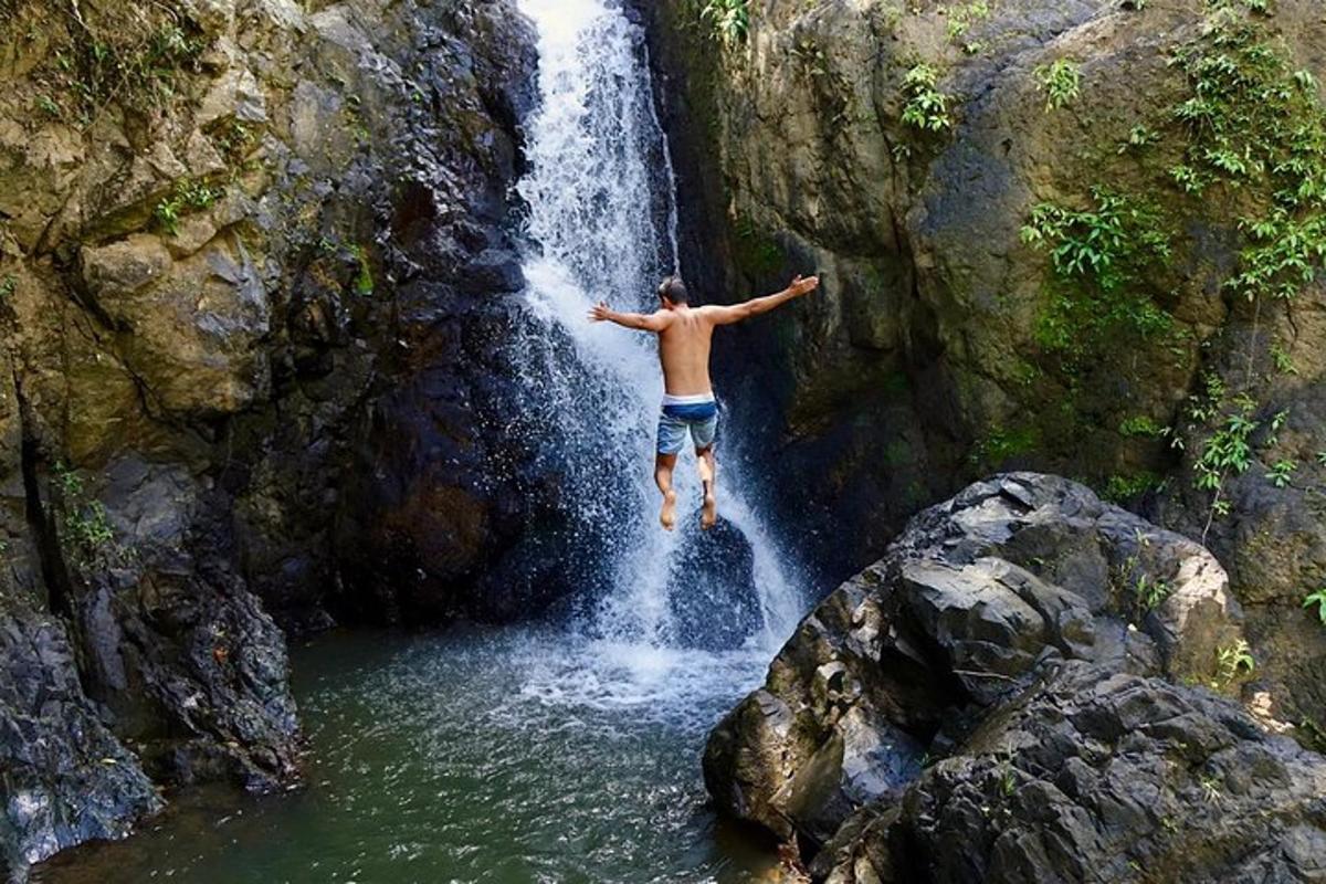 a man is jumping into a waterfall
