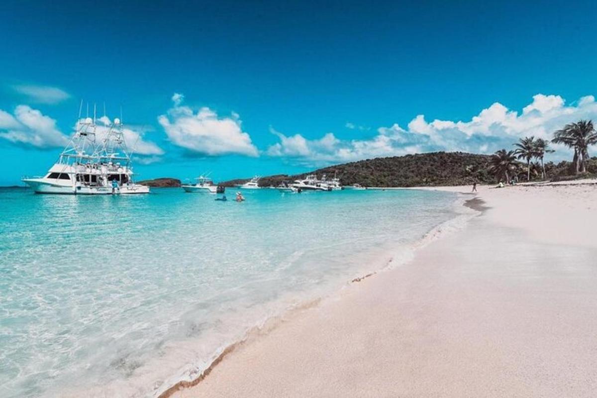 a boat in the water next to a beach