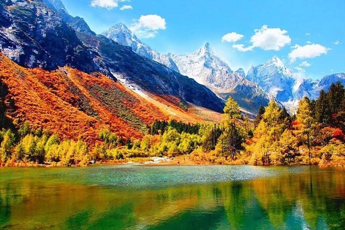 a lake in front of a mountain with autumn foliage