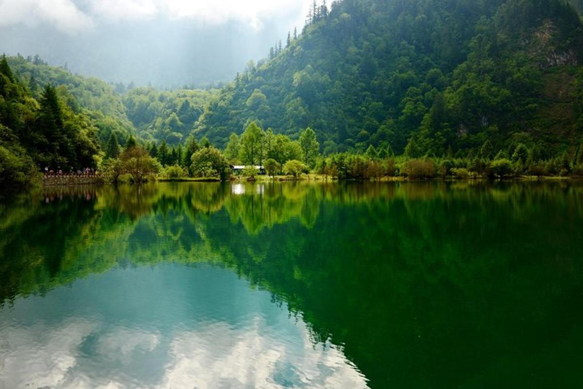 a reflection of a mountain in a lake