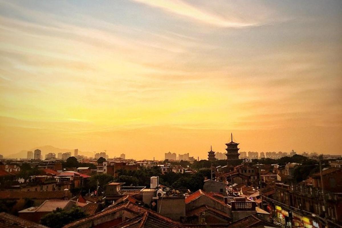 a view of a city with a sunset in the background