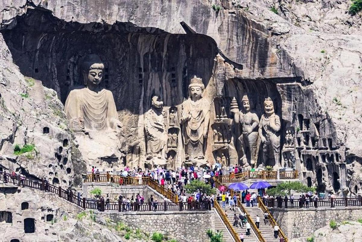 a group of people standing in front of a statue